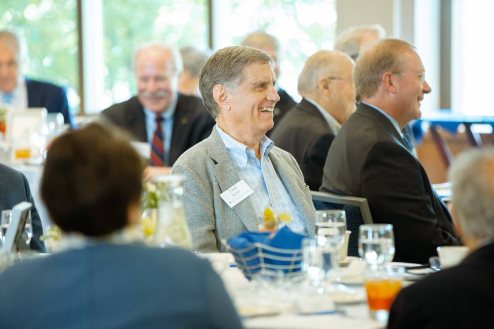 Guest smiling at a speaker at the Foundation Annual Meeting